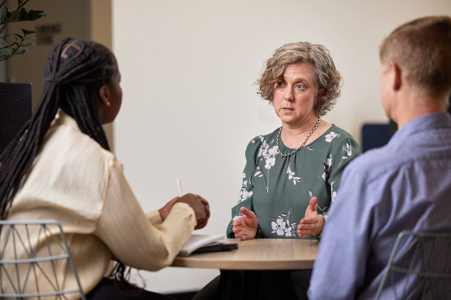 Provider and trainer sitting at a table talking about training options for staff