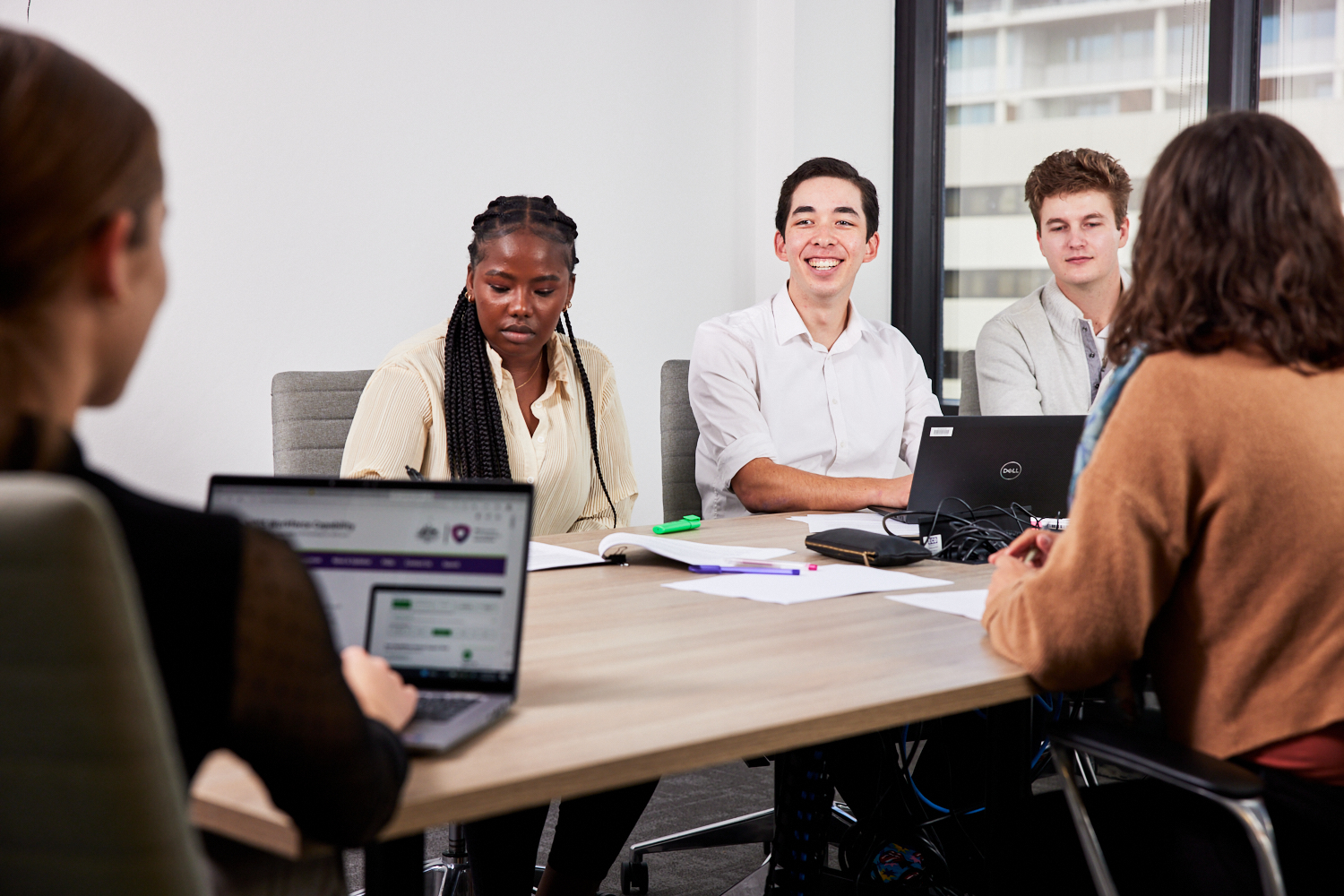 CEO presenting to the Board in a meeting room sitting around a table about delivering new services to participants in remote areas