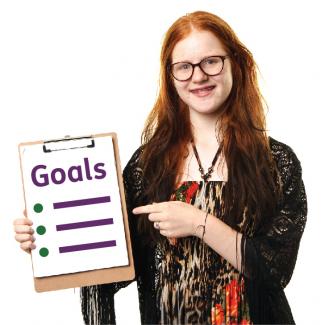 A young woman holding a list of goals